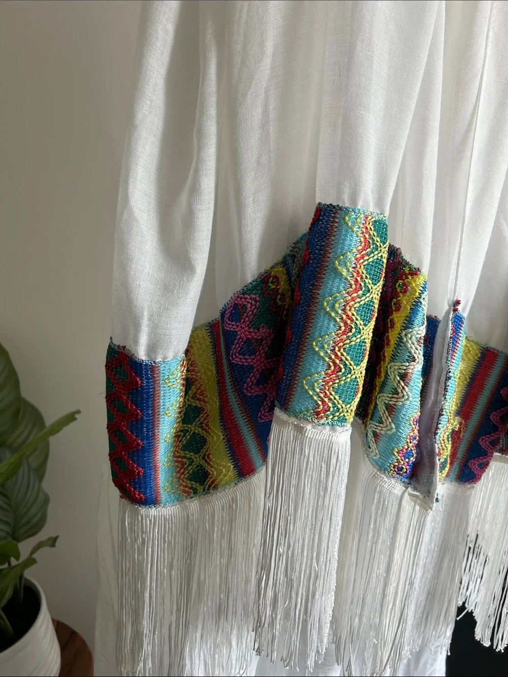 World Market white fringe scarf with red blue yellow green stitching